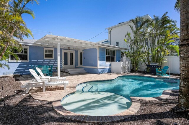 rear view of house featuring a fenced in pool, fence, french doors, a pergola, and a patio