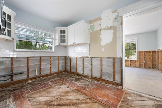 kitchen with white cabinets and glass insert cabinets