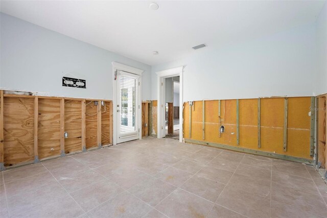 empty room featuring tile patterned floors and visible vents