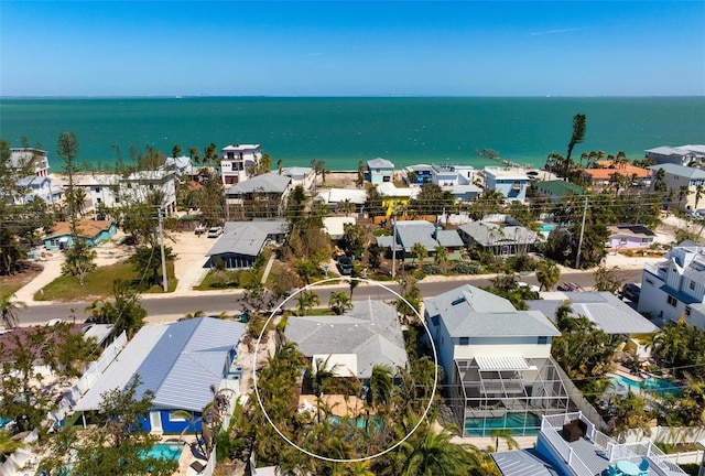 birds eye view of property with a residential view and a water view