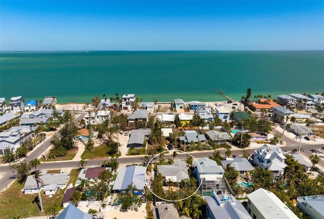 drone / aerial view featuring a residential view and a water view