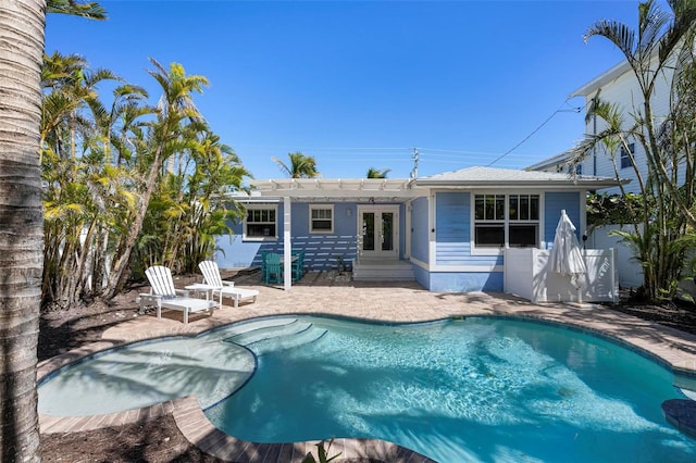 back of house with fence, a fenced in pool, a pergola, french doors, and a patio area