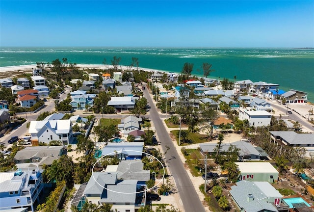 drone / aerial view featuring a residential view and a water view