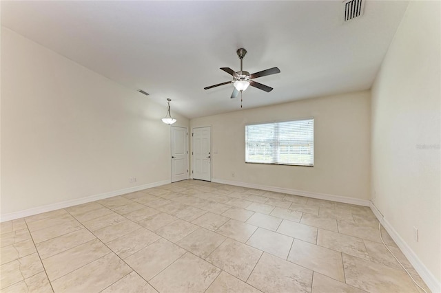 unfurnished room with visible vents, ceiling fan, and baseboards