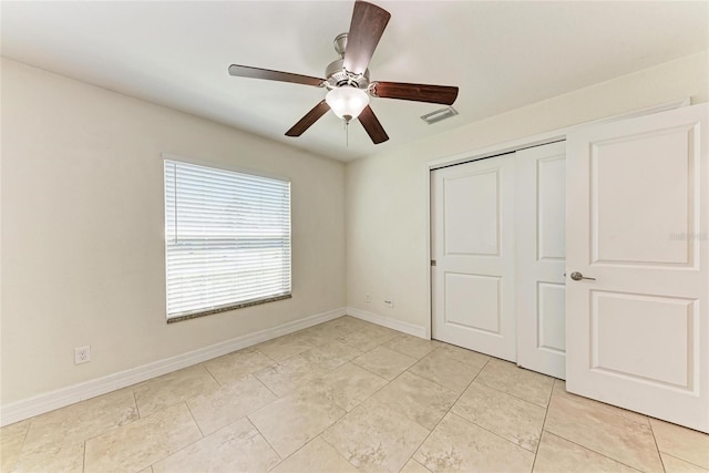 unfurnished bedroom with baseboards, visible vents, ceiling fan, and a closet