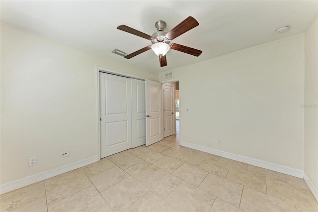 unfurnished bedroom with a ceiling fan, baseboards, visible vents, and a closet