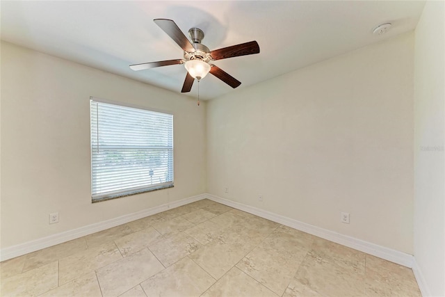 unfurnished room featuring a ceiling fan and baseboards