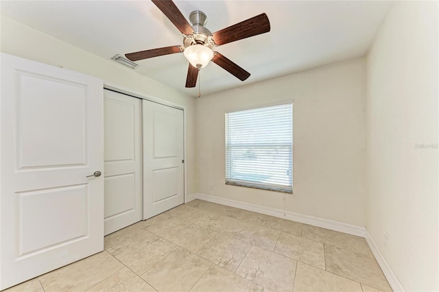 unfurnished bedroom with a ceiling fan, a closet, visible vents, and baseboards