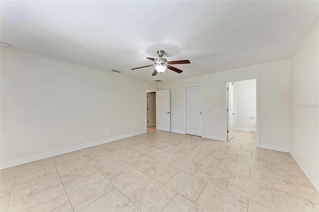 unfurnished bedroom featuring visible vents, ceiling fan, baseboards, and ensuite bathroom