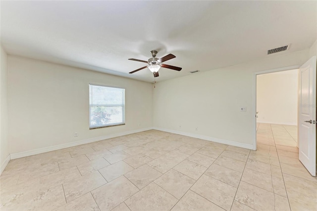 unfurnished room with light tile patterned floors, ceiling fan, visible vents, and baseboards