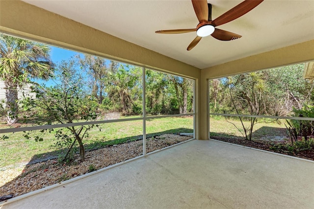 unfurnished sunroom featuring a ceiling fan