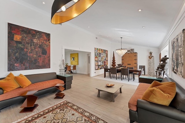 living room featuring ornamental molding, light wood-type flooring, a notable chandelier, and recessed lighting