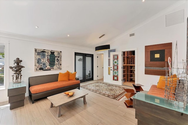 living area featuring lofted ceiling, french doors, visible vents, and crown molding