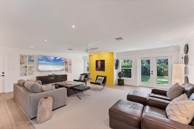 living room featuring light wood-type flooring, recessed lighting, visible vents, and french doors