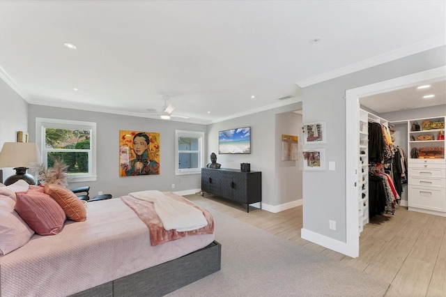 bedroom with baseboards, light wood-type flooring, and crown molding