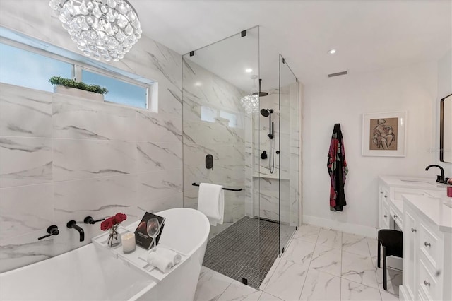 bathroom featuring a freestanding tub, vanity, visible vents, marble finish floor, and a marble finish shower