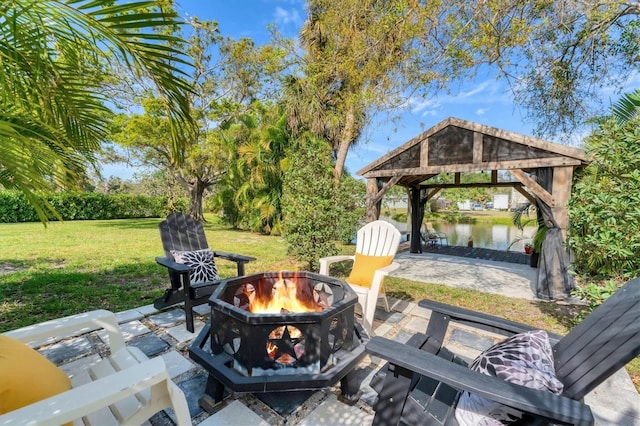 view of patio / terrace with a gazebo, an outdoor fire pit, and a water view