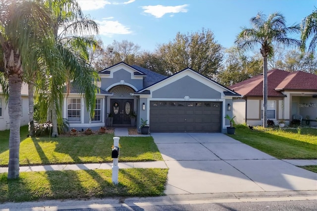 view of front of house featuring a garage, concrete driveway, a front lawn, and stucco siding