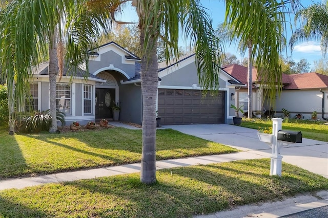 view of front facade featuring a front lawn, driveway, an attached garage, and stucco siding