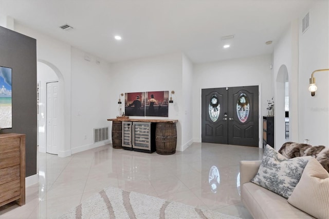 entryway with arched walkways, visible vents, and recessed lighting