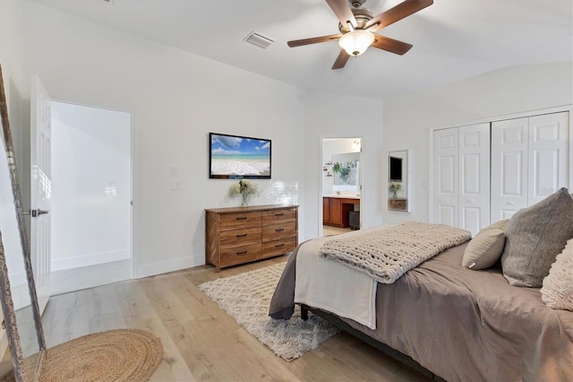 bedroom featuring visible vents, ensuite bath, light wood-style flooring, ceiling fan, and a closet