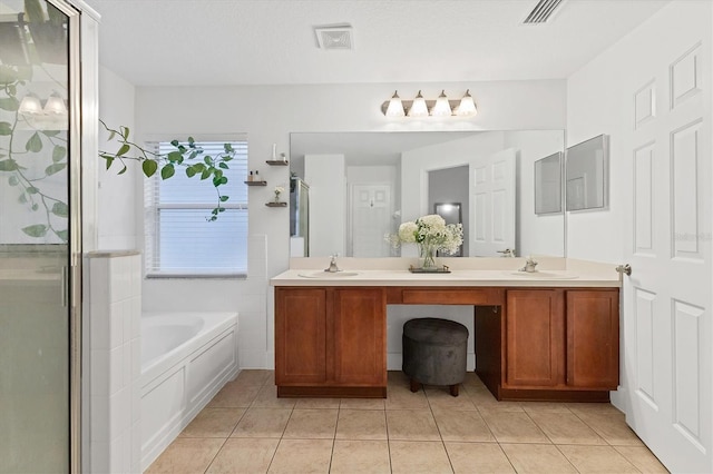 full bathroom featuring double vanity, a garden tub, and a sink