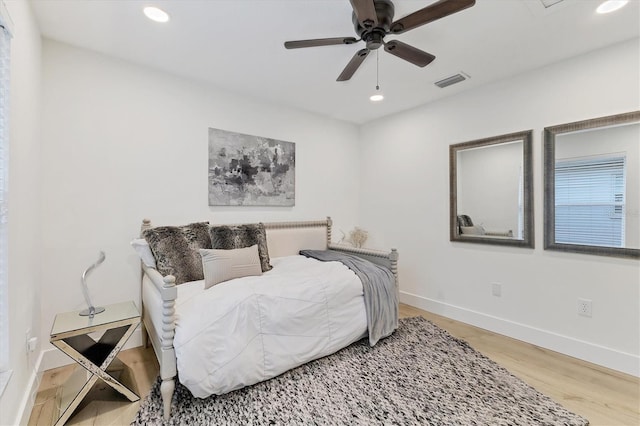 bedroom featuring ceiling fan, recessed lighting, wood finished floors, visible vents, and baseboards