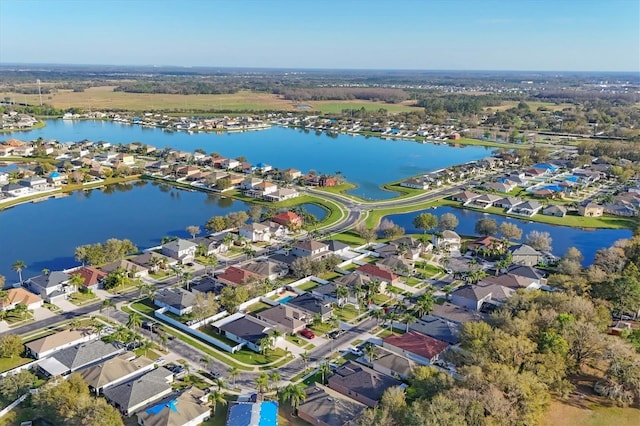 birds eye view of property with a water view and a residential view