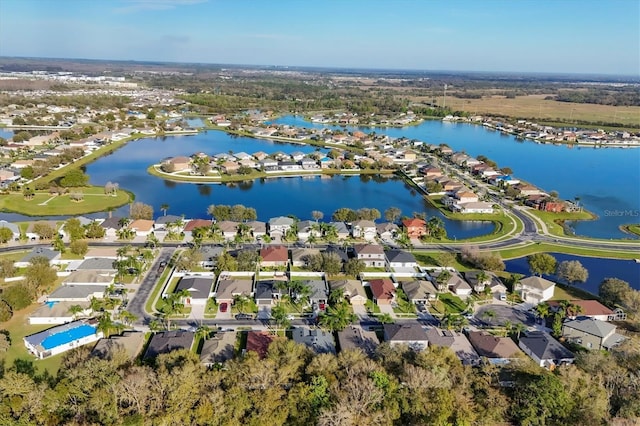 drone / aerial view featuring a residential view and a water view