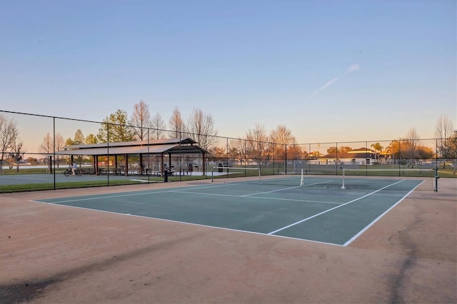 view of sport court featuring fence