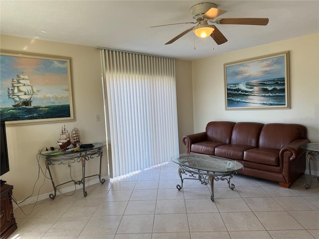 living room featuring light tile patterned floors, ceiling fan, and baseboards