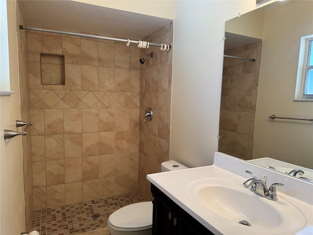 full bathroom featuring toilet, a shower stall, and vanity