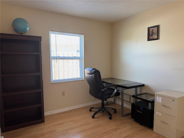 office space featuring light wood-style flooring and baseboards