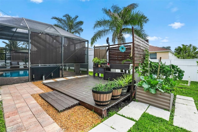 wooden terrace featuring a fenced in pool, a lanai, and fence