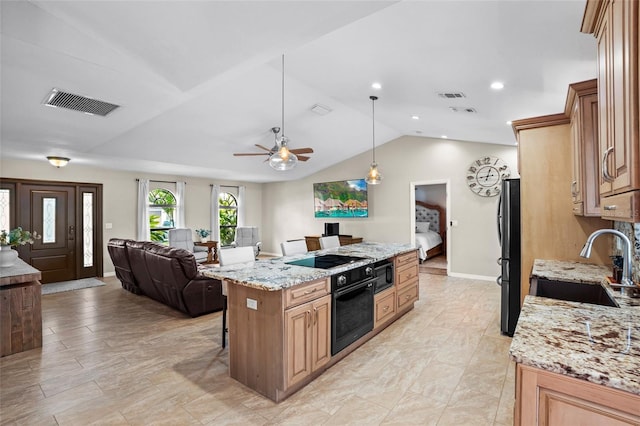 kitchen with open floor plan, black appliances, a sink, and visible vents