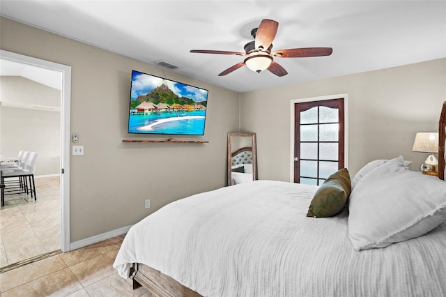 bedroom featuring light tile patterned floors, a ceiling fan, visible vents, and baseboards