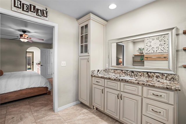 bathroom with recessed lighting, a ceiling fan, vanity, ensuite bath, and baseboards