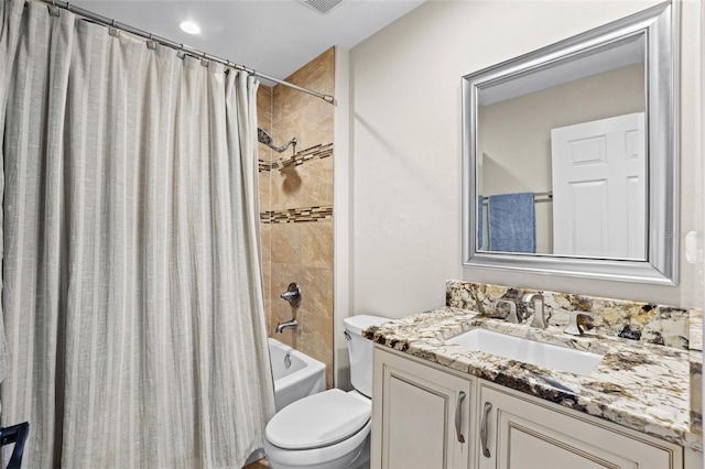 bathroom featuring shower / bathtub combination with curtain, vanity, and toilet