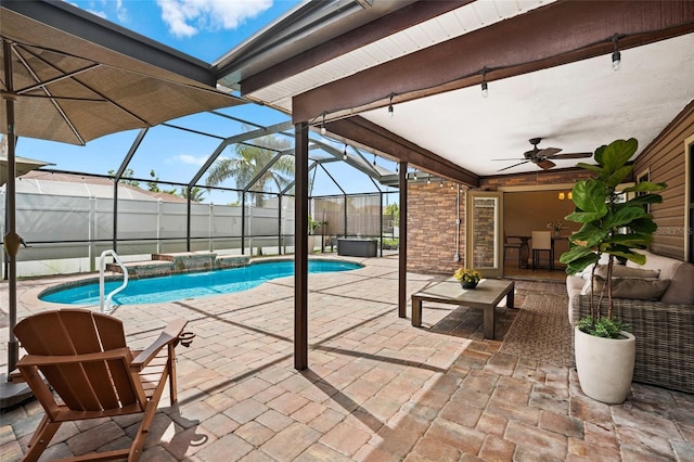 pool featuring a hot tub, ceiling fan, a lanai, and a patio