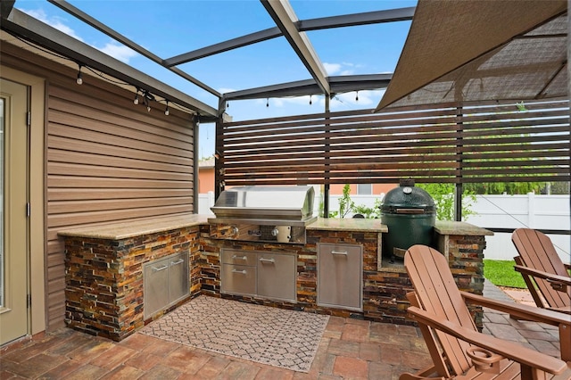 view of patio / terrace with glass enclosure and area for grilling