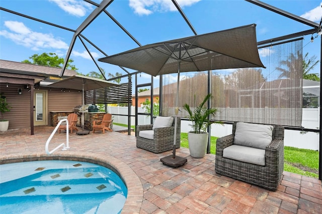 view of patio / terrace with outdoor dry bar, fence, a jacuzzi, and a lanai