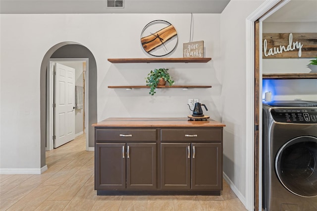 interior space featuring washer / clothes dryer, visible vents, baseboards, and laundry area