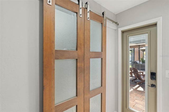 doorway to outside featuring a barn door and french doors