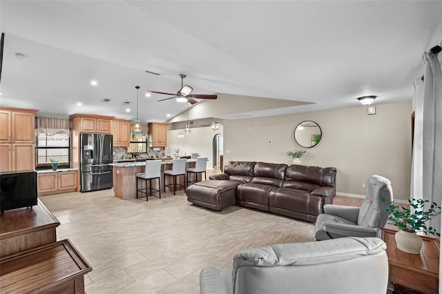 living area featuring lofted ceiling, ceiling fan, and recessed lighting