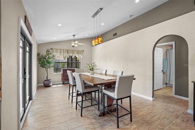 dining room with baseboards, arched walkways, lofted ceiling, ceiling fan, and recessed lighting