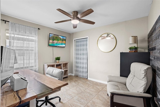 office area featuring a ceiling fan and baseboards