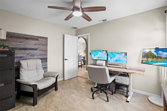 office with baseboards, visible vents, and a ceiling fan