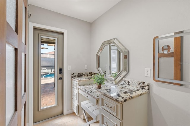 bathroom with tile patterned flooring and vanity