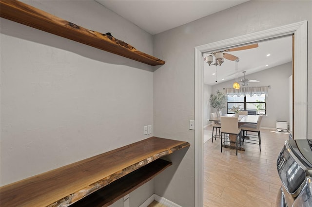 interior space with vaulted ceiling and ceiling fan