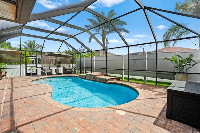 view of pool with a fenced in pool, glass enclosure, and a patio